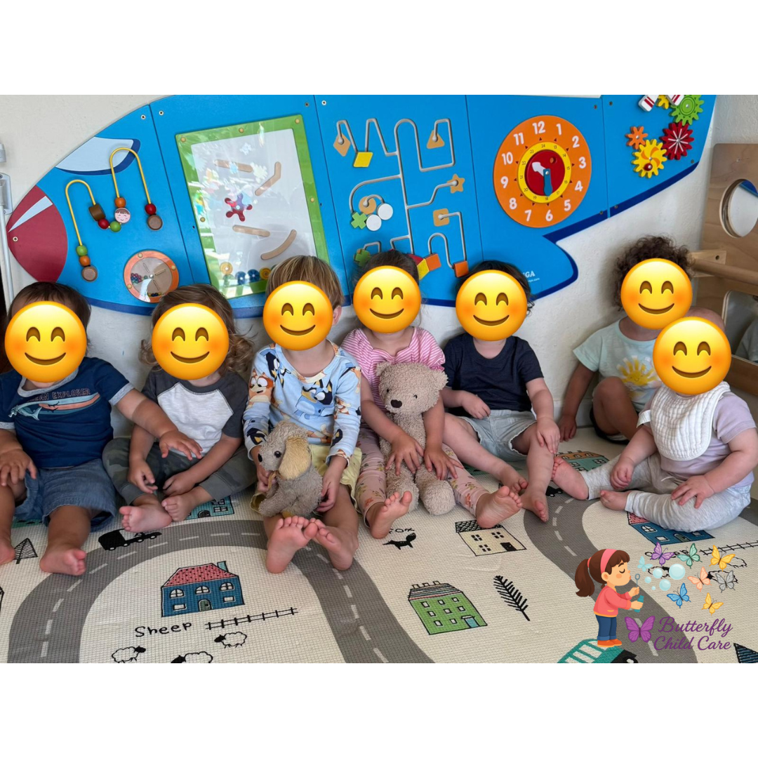 Group of toddlers sitting in a playful classroom with educational wall games