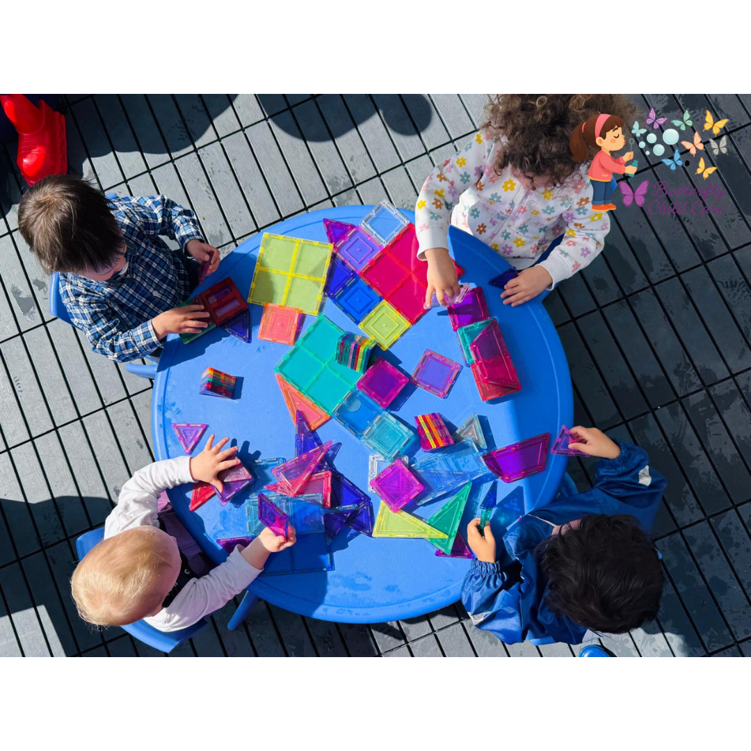 Children playing with colorful magnetic blocks at Butterfly Child Care