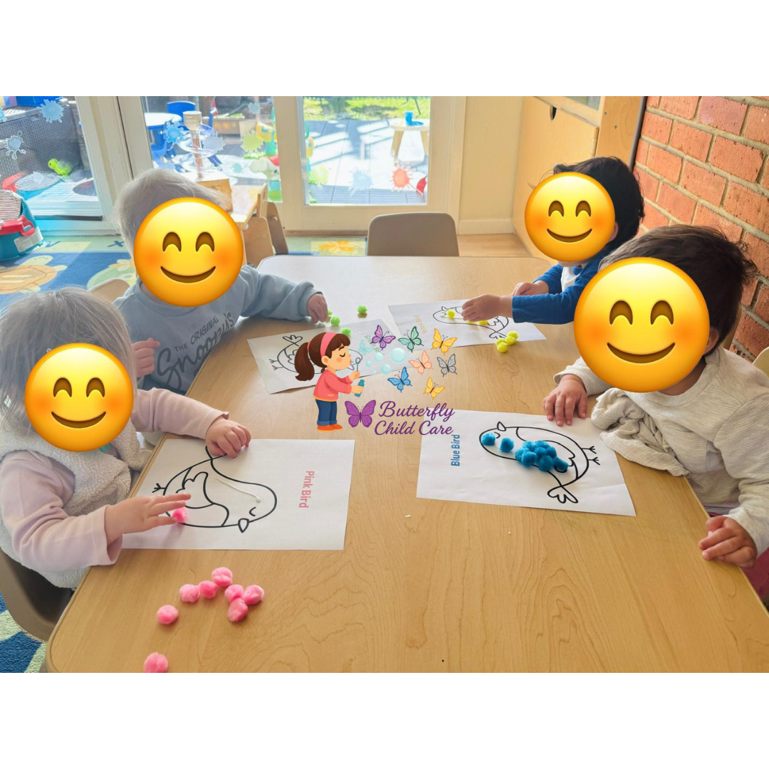 Toddlers doing creative art with pom-poms and coloring sheets at Butterfly Child Care