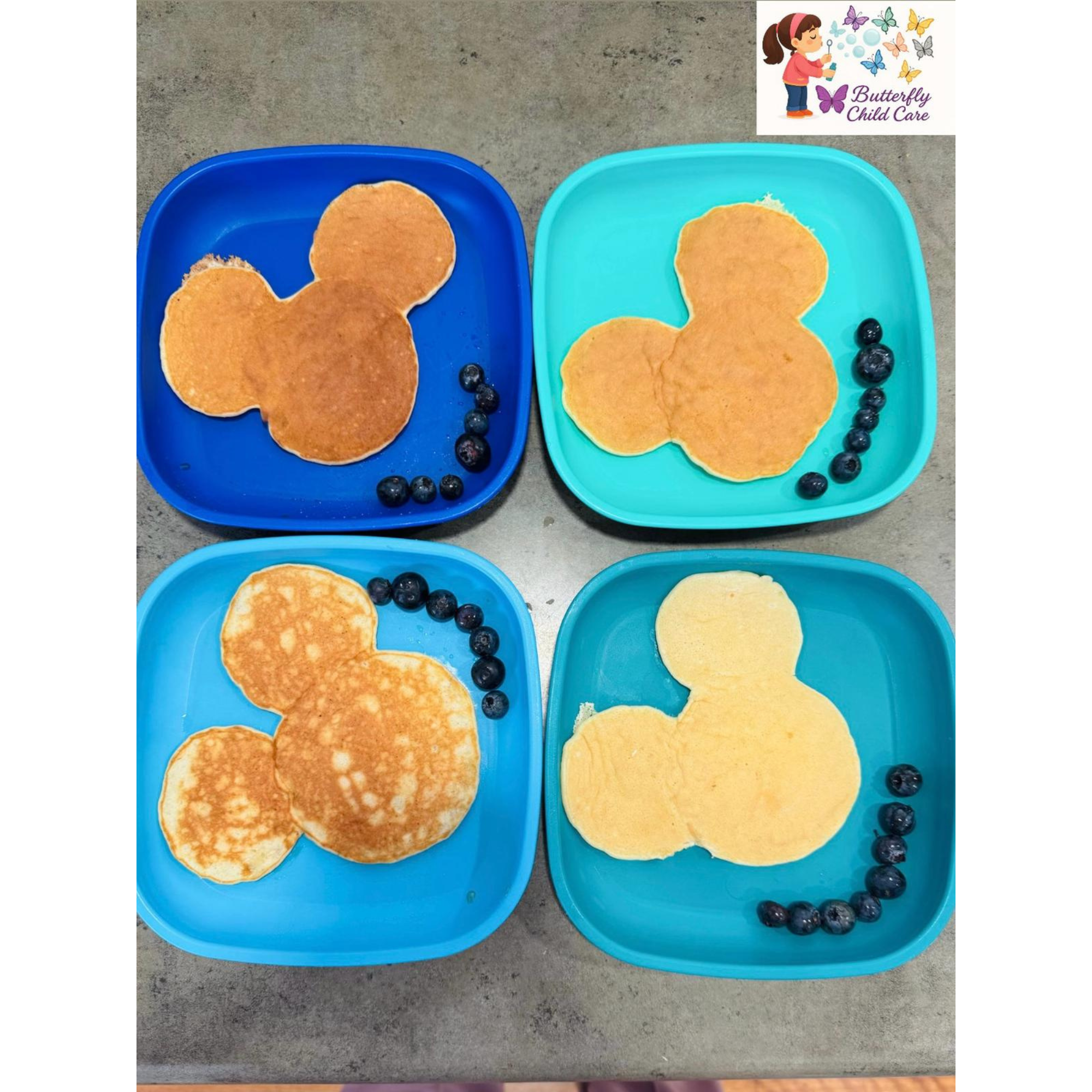 Mickey-shaped pancakes with blueberries served at Butterfly Child Care