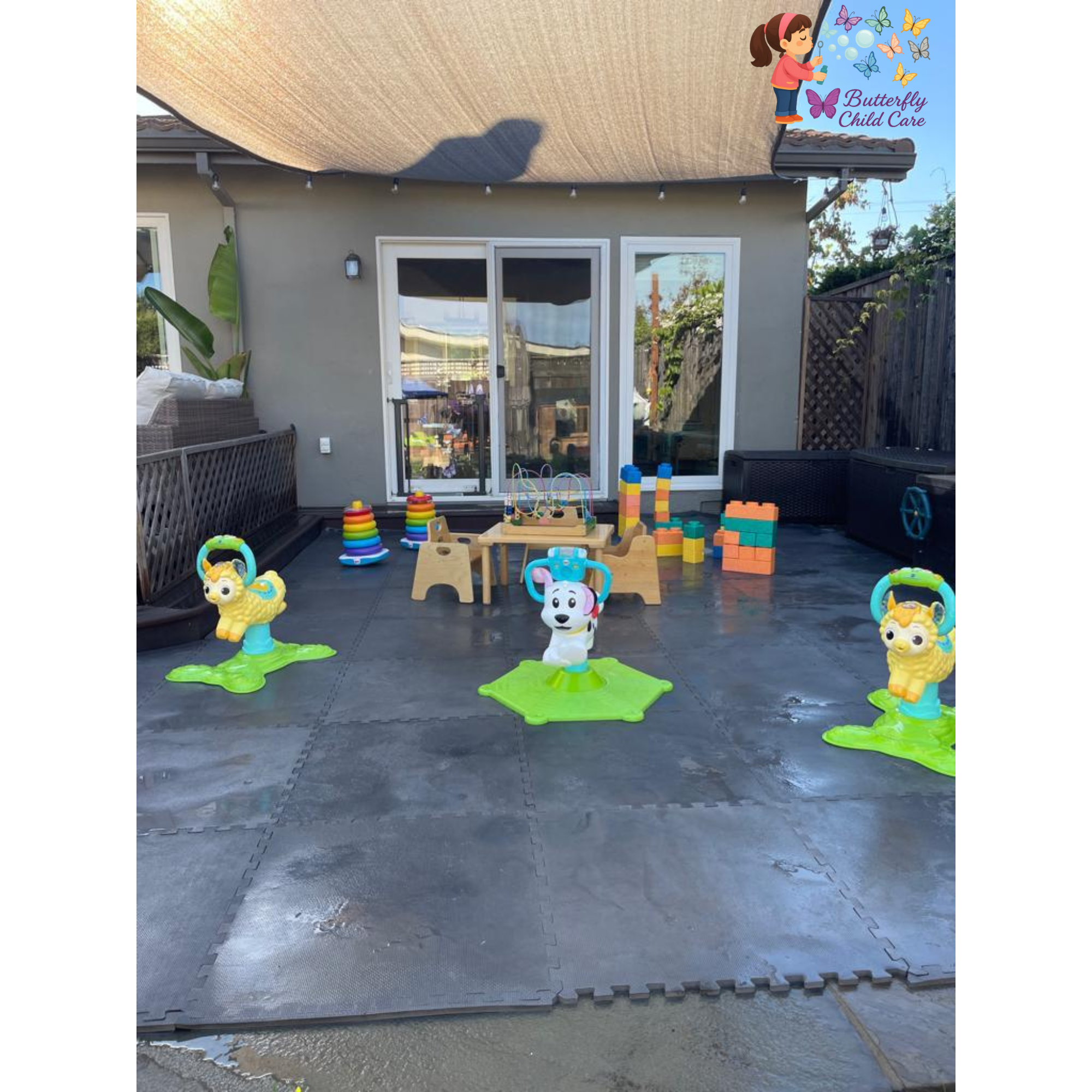 Outdoor play area with ride-on toys and giant blocks for toddlers